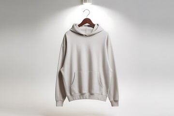 Blank light gray hoodie on a hanger with soft pink lining in studio lighting