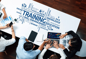 A diverse group of professionals engaged in a collaborative training session to enhance skills and knowledge, utilizing modern technology for effective learning outcomes. Amity