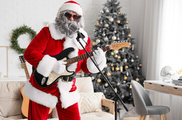 Cool Santa Claus with guitar and microphone singing at home