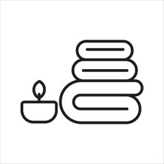 Minimalist spa and relaxation symbol with neatly folded towels and a glowing candle for wellness and comfort