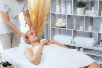 Caucasian woman enjoying relaxing anti-stress head massage and pampering facial beauty skin...