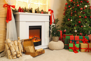 Stylish interior of living room with beautiful fireplace, Christmas tree and decor