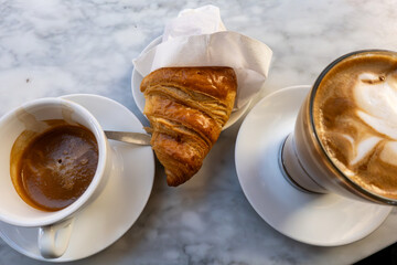 Stockholm, Sweden  An espresso, cappuccino, and croissant at an outdoor cafe.