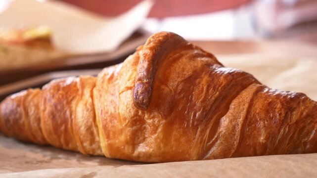 Enjoying fresh croissant at cozy bakery in France