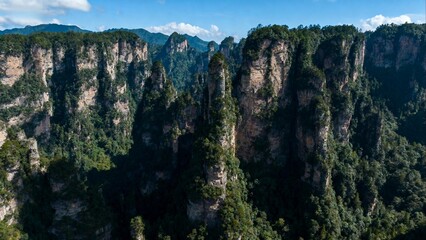 Naklejka premium Towering rock formations covered in greenery