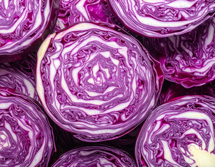 Obraz premium Red cabbage cross-sections arranged in pattern, vibrant purple vegetable background 