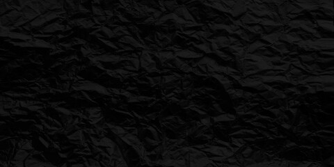 Dark rough textured wall for background and artwork. Black crumpled paper. Dark grunge background texture.