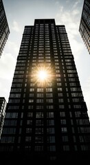 Tall Building Facade with Sunlight Bursting Through Windows and Blue Sky View