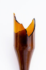 A broken brown glass bottle with sharp jagged edges at the top.
