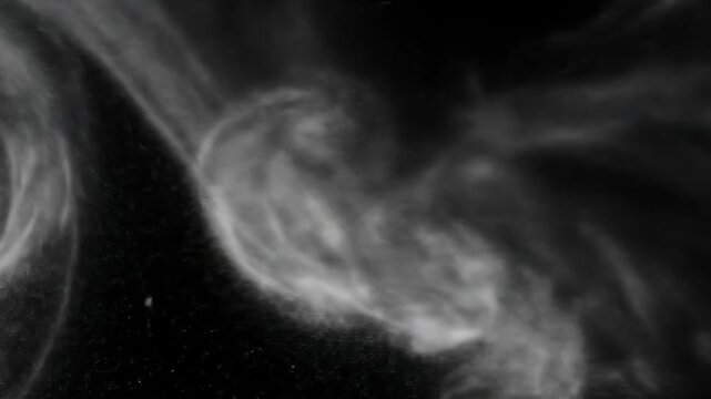 Abstract swirling smoke patterns in monochrome for background use.