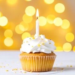 Birthday cupcake with candle against a blurred yellow background