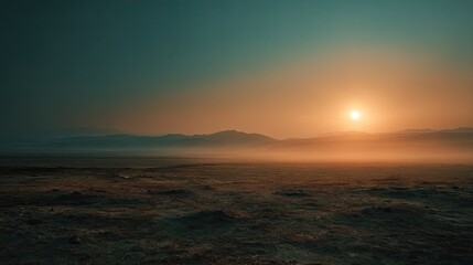 Obraz premium Sunrise over a vast, hazy plain. Misty mountains in the distance (1)