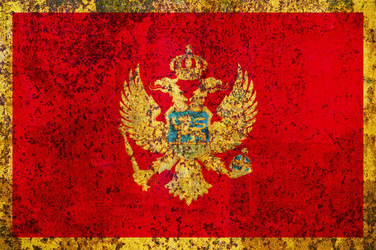 A textured and weathered rendering of the flag of Montenegro, showcasing its central golden heraldic eagle with a shield, set against a field of red with a golden frame, evoking a