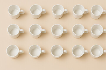 Minimalist coffee cup grid arranged in simple composition, showcasing empty white cups on soft beige background. This design evokes sense of calm and order