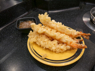 Fresh Golden Crispy Tempura Shrimp Prawns with Dipping Sauce on Yellow Plate - Traditional Japanese Deep Fried Seafood Dish.