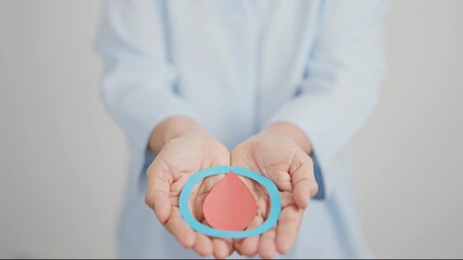 Elderly woman with Blue Circle and red Blood drop for World Diabetes Day, Blue November Health month, Diabetes awareness, Blood sugar check, Insulin, Glucose screening, donation and Health checkup