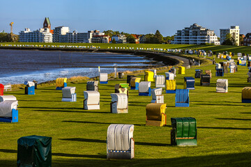 Germany. Cuxhaven. Promenade along the Elbe with numerous colorful roofed wicker beach chairs