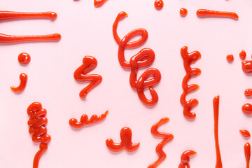 Different patterns made of tasty ketchup on pink background