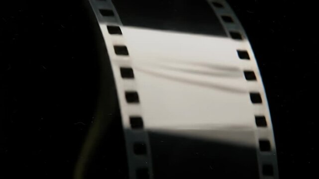 Close up of vintage film strip with perforations and blank frames.