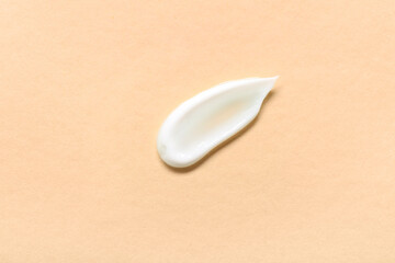 Obraz premium Sample of cosmetic cream on beige background