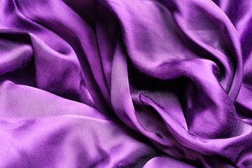 Texture of silk violet fabric with folds as background, closeup