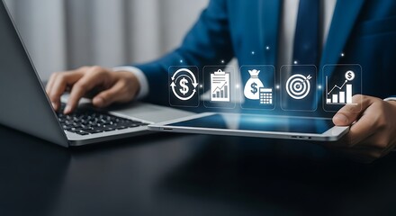Businessman using laptop and tablet with financial and business icons floating above