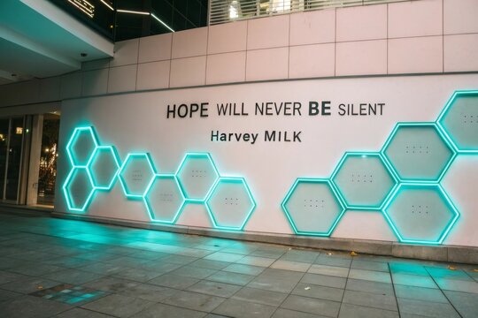 Bright wall with neon hexagonal lights and an inspirational quote