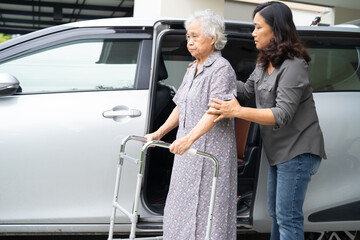 Asian senior woman patient sitting on walker prepare get to her car, healthy strong medical concept.