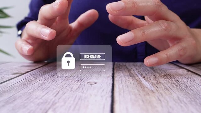 Close-up of a person's hands at a table protecting an animation of a logging interface with username and password
