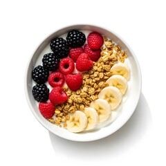 A white bowl filled with yogurt granola fresh raspberries blackberries and sliced bananas