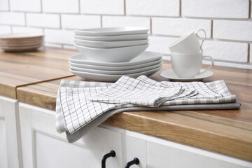 Clean dishware and napkins on counters in kitchen, closeup