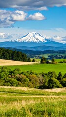 Fototapeta premium Scenic mountain vista over green fields