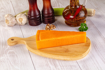 Yellow cheddae cheese over board