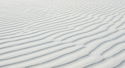 Obraz premium White sand texture background with wave pattern, top view natural beach surface design.