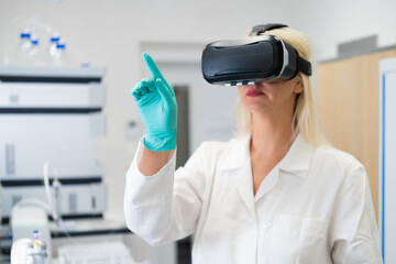 Scientist in protective coat and VR headset visualizing chemical structures and data in modern lab environment.