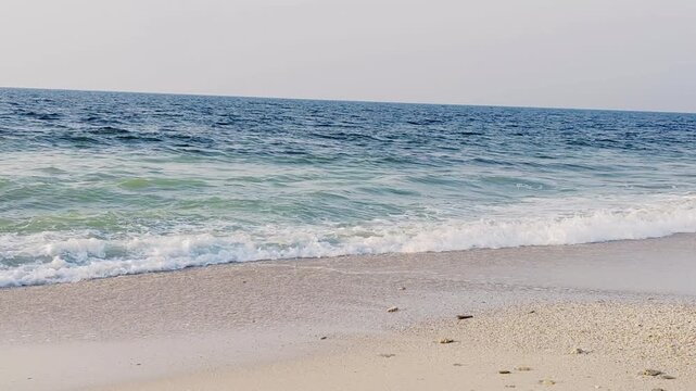 Water waves Sea Shore Beautiful Panorama white sand beach and turquoise water View.
Holiday summer beach background, Wave of sea on White sandy beach.
Enjoy Holiday on Public Beach Heavy Water Waves