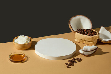Cosmetic podium, coconuts, and coffee beans arranged on warm surface. Composition creates space for cosmetic product design or skincare ads. Product presentation