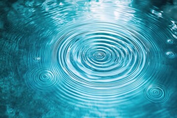 Close-up of concentric water ripples spreading on a calm blue surface, creating a soothing and peaceful effect