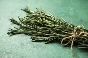 Bunch of fresh rosemary on green grunge background