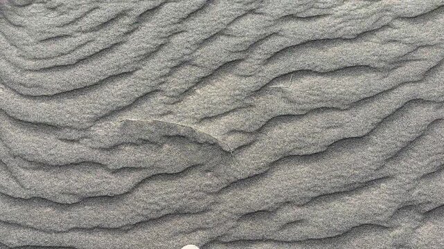 4k footage of walking on a unique texture of volcanic sand. Sea of sand texture from the wind abrasion and storm, creating such rippled streams and embossed wavy texture.