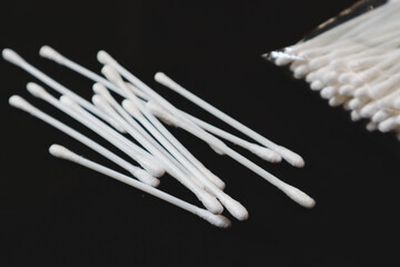 Cotton buds for health purposes. Taken on a black background.
