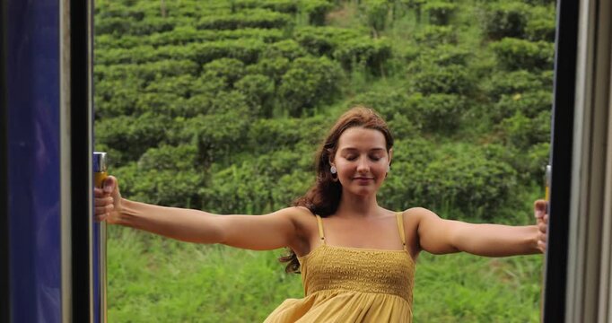 Young Woman Enjoying Scenic Train Ride In Sri Lanka Tea Plantation