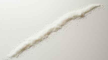 Fototapeta premium Granulated white sugar scattered in diagonal line on studio backdrop