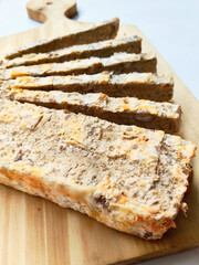 Appetizing Slices of Sundanese Oncom Cake or Biscotti Featuring Crunchy Nuts and Rustic Wood