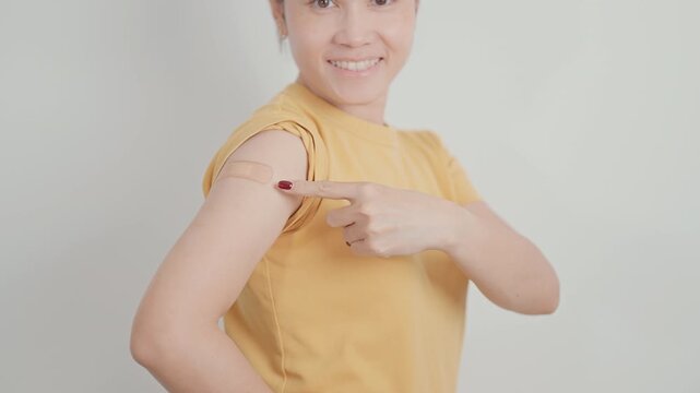 Adult Woman with bandage after received vaccine. Vaccination and Immunization for Influenza, HPV, Zoster, IPD, DTP or Diphtheria, Tetanus and Pertussis, MMR, Hepatitis B, Covid and Varicella vaccine