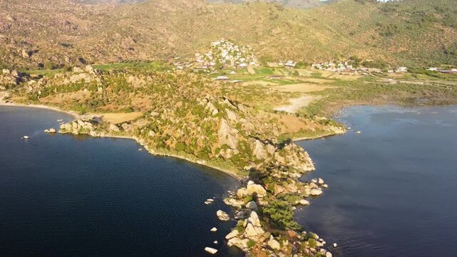 Drone footage captures the stunning natural beauty and rich history of Lake Bafa Nature Park in Turkey. Featuring panoramic views of the serene Bafa Lake, the rugged Latmos Beşparmak Mountains, and th