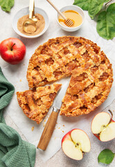 Homemade apple pie with ingredients on concrete background