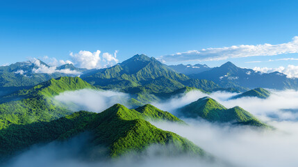Fototapeta premium Breathtaking mountain landscape featuring lush green hills and dramatic peaks surrounded by misty clouds under clear blue sky