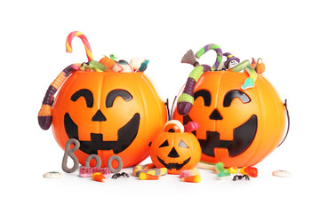 Cauldrons in shape of pumpkin with candies for Halloween isolated on white background, closeup