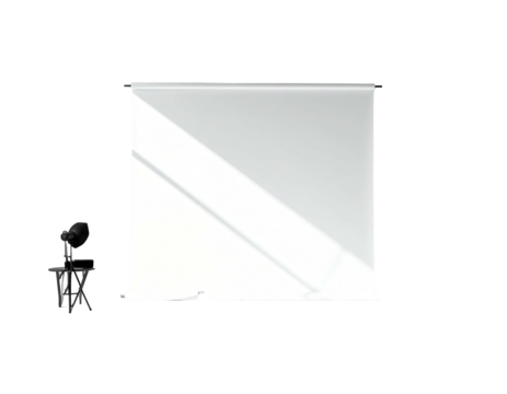 White screen and microphone stand in a dark room, angled lighting